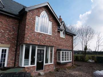 Heswall , Wirral Installtion of Evolution Storm PvcU Windows, also showing an arched Timber frame from G Barnsdales showing how Timber and Timber look windows can sit togeather 